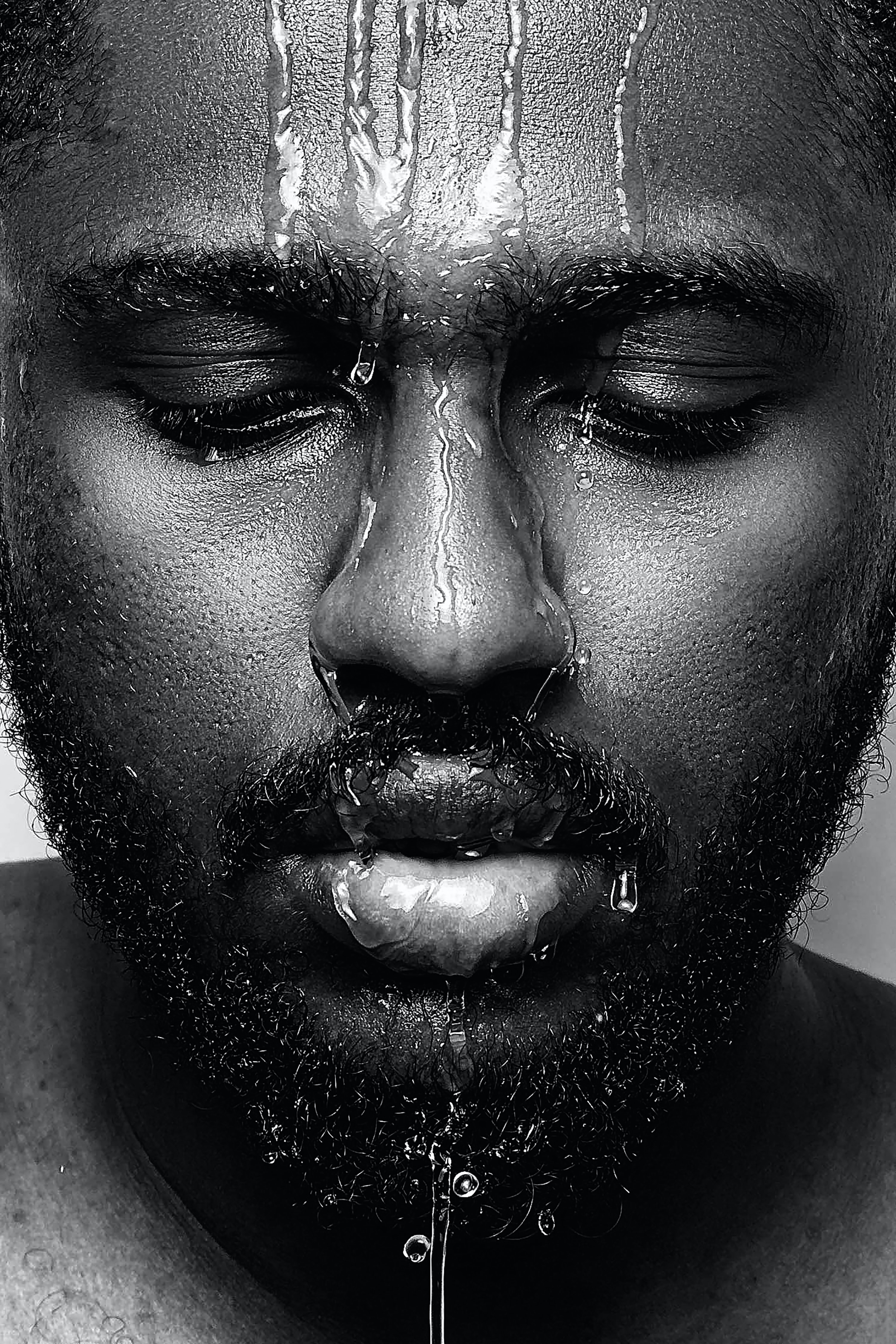 black and white photograph image of a man with water over him 